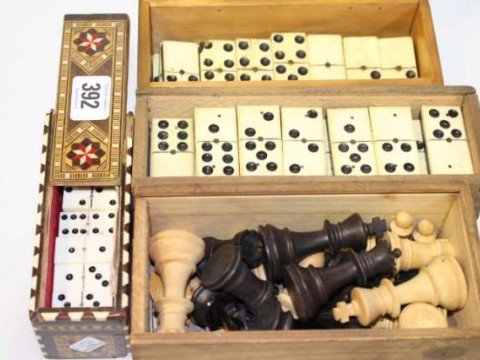 Box of chess pieces and three boxes of dominoes
