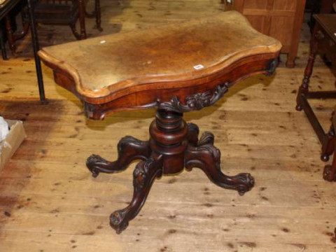 19th Century walnut serpentine front fold top card table on turned pedestal...