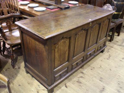 Oak two drawer mule chest, the front having four fielded arched panels