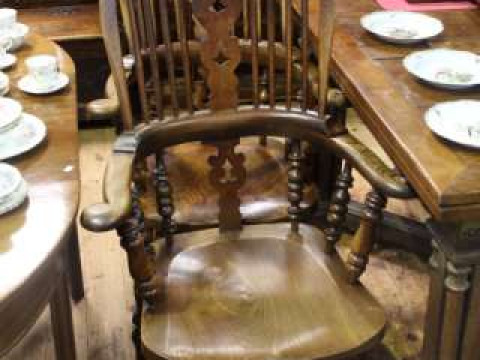 Near pair of Windsor elm pierced splat back elbow chairs