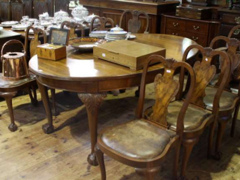 Oval walnut extending dining table and eight Queen Anne style dining chairs...