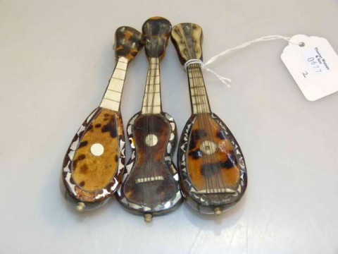 Three tortoiseshell miniature stringed instruments