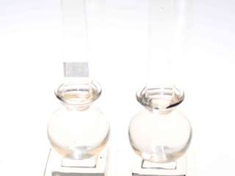Pair glass obelisks on ball and stepped bases