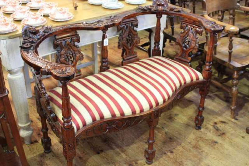 Carved mahogany serpentine seated occasional settee