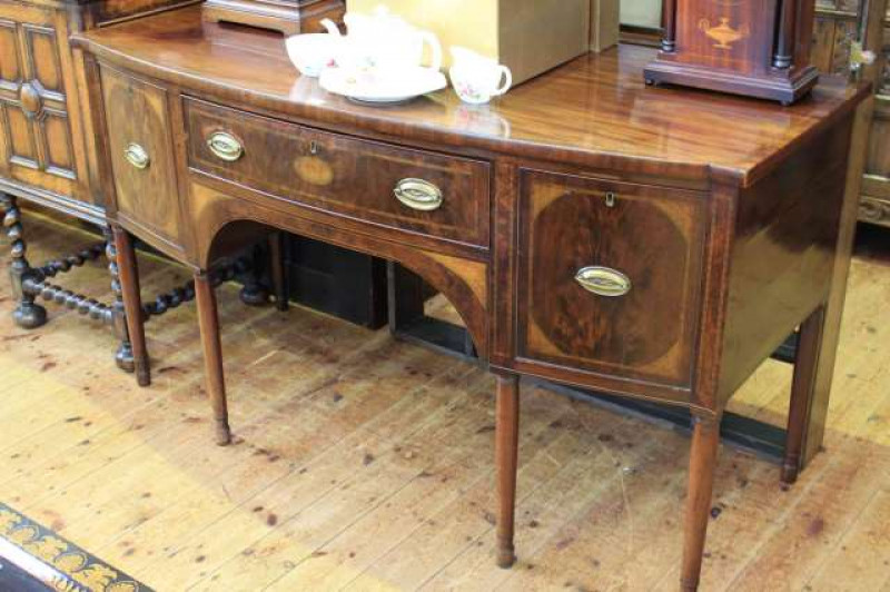 Georgian mahogany and satinwood inlaid bow front sideboard on six turned legs