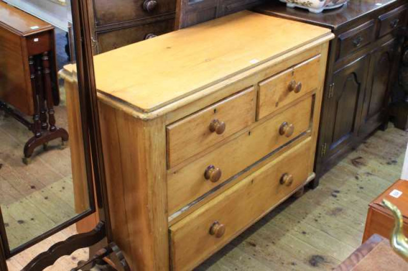 Waxed pine chest of two short above two long drawers on turned feet