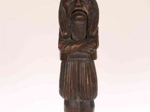 A FRENCH CARVED WOODEN NUTCRACKER, late 19th Century, modelled as a Breton...