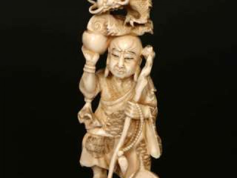 A JAPANESE MARINE IVORY OKIMONO, Meiji period (1868-1912), carved as a...