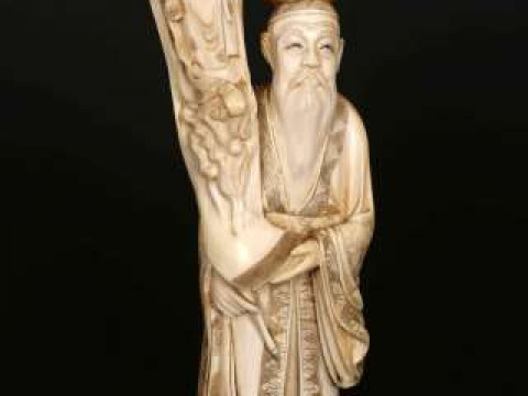 A JAPANESE IVORY OKIMONO, Meiji period (1868-1912), carved as an elder...