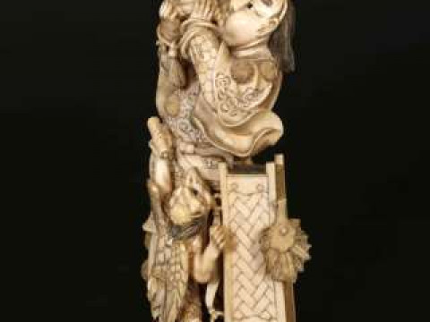 A JAPANESE IVORY OKIMONO, Meiji period (1868-1912), carved as a samurai...