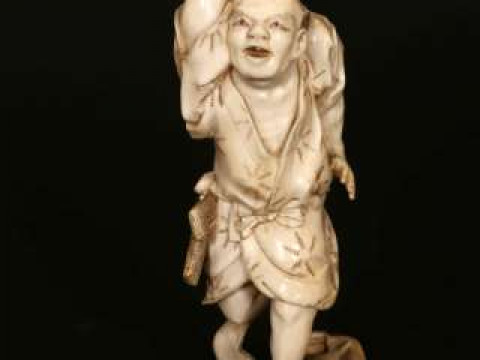 A JAPANESE IVORY OKIMONO, Meiji period (1868-1912), carved as a fisherman...