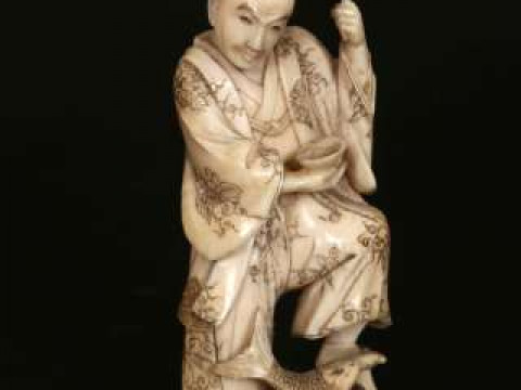 A JAPANESE IVORY OKIMONO, Meiji period (1868-1912), carved as a farmer...