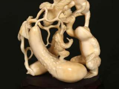 A JAPANESE IVORY OKIMONO, early 20th Century, carved as three toads climbing...