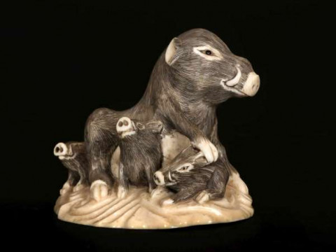 A FINE JAPANESE IVORY OKIMONO OF A BOAR AND CUBS, carved as a sow and...