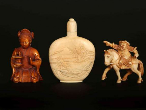 A CHINESE STAINED IVORY FIGURE OF A DEITY, 19th/early 20th Century, carved...