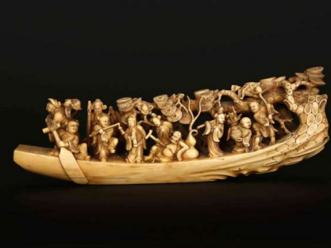 A CHINESE MARINE IVORY CARVING, 19TH CENTURY, depicting figures on a rustic...