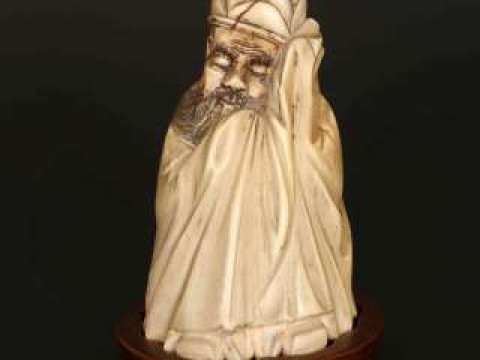 A CHINESE IVORY FIGURE, 19th Century, carved as a bearded man sleeping,...
