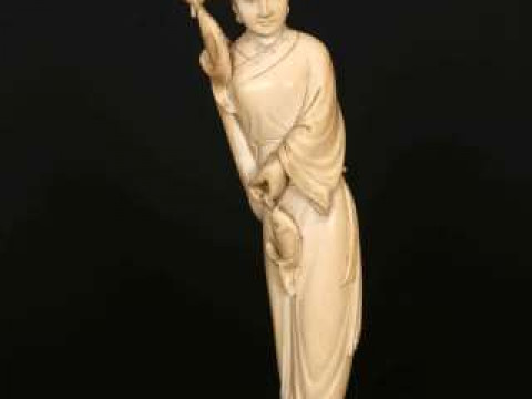 A CHINESE IVORY FIGURE OF GUANYIN, late 19th/early 20th Century, carved...
