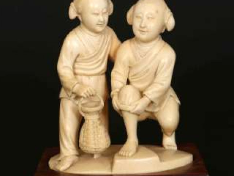 A CHINESE IVORY FIGURE GROUP, early 20th Century, carved as two children...