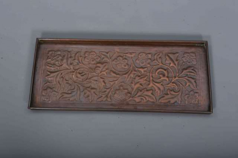 KESWICK SCHOOL OF INDUSTRIAL ART, AN ARTS AND CRAFTS COPPER TRAY, repousse with stylised foliage within a gallery with rolled rim, stamped KSIA. 53cm by 24cm