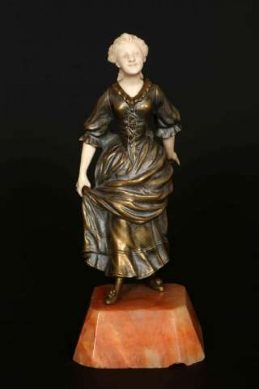LOUIS BARTHELEMY (FRENCH), A GILT BRONZE AND IVORY FIGURE, EARLY 20TH CENTURY, cast and carved as a girl in a flowing dress, signed in the cast L. Barthelemy, raised on an onyx plinth. Overall 19cm