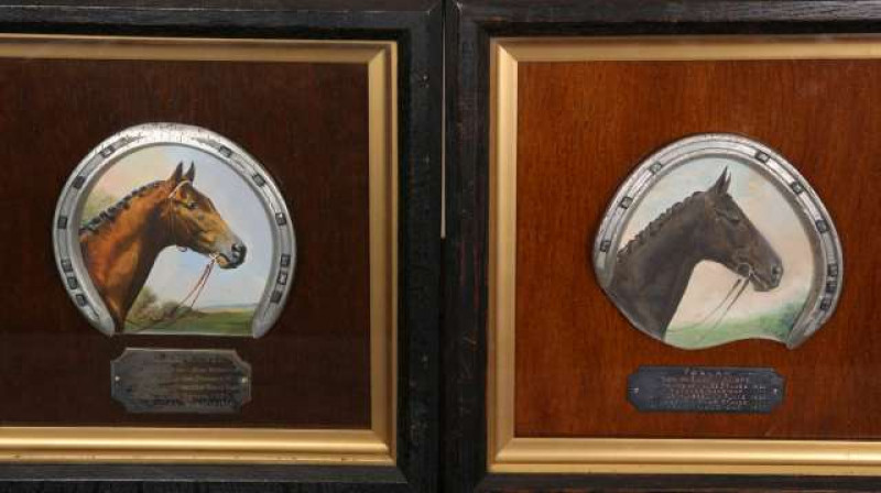 HORSE RACING INTEREST: A PAIR OF PORTRAITS OF 'FOXLAW' AND 'SOLARIO', each painted in oils within a horseshoe and framed with a plaque detailing their achievements, one inscribed verso Actual shoe worn by Foxlaw in the Ascot Gold Cup 1927. Frames 26cm by 