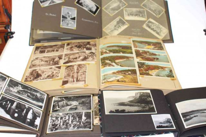 Four albums of photographs and postcards