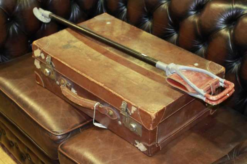Vintage leather suitcase and shooting stick