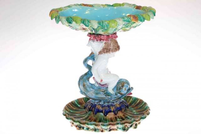 Victorian large Majolica centrepiece with fern and leaf moulded bowl raised by figure of putti riding a dolphin
