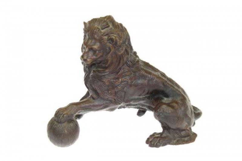 Bronze figure of a lion with a ball underfoot