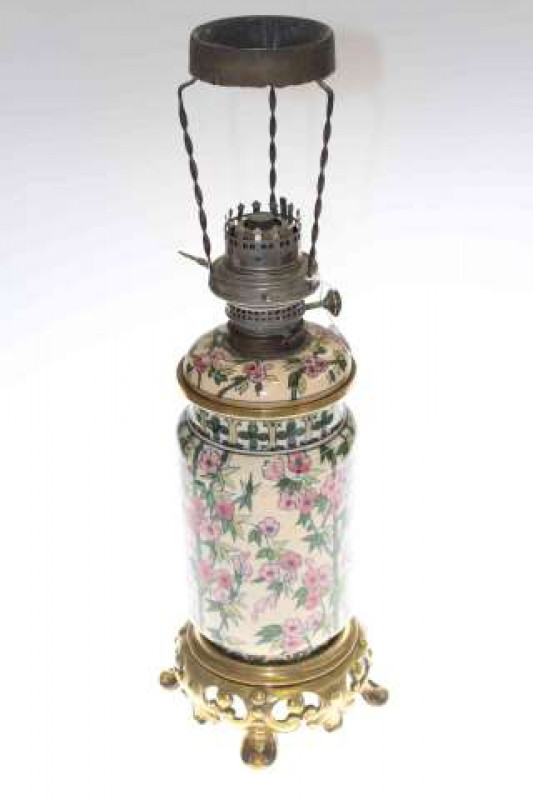 Gilt metal and pottery oil lamp with floral decoration