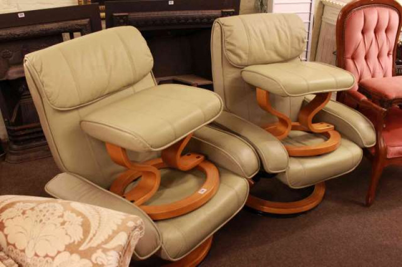 Pair of adjustable swivel easy chairs and footstools in sage green leather