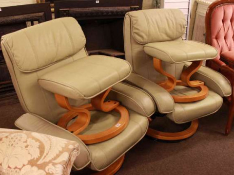Pair of adjustable swivel easy chairs and footstools in sage green leather
