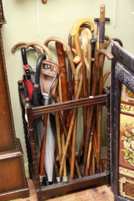 Oak bobbin leg stick stand and collection of sticks and brollies