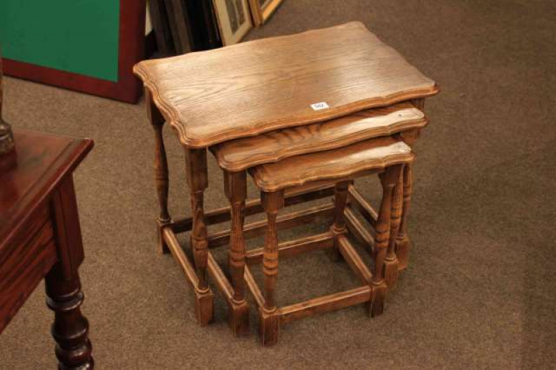 Nest of three oak wavy edge tables