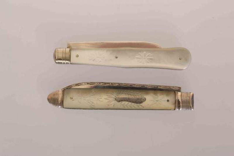 A GEORGIAN SILVER AND MOTHER-OF-PEARL FOLDING FRUIT KNIFE, the mother-of-pearl engraved with Prince of Wales feathers, 8.5cm (closed); and A GEORGE V SILVER AND MOTHER-OF-PEARL FRUIT KNIFE, Sheffield 1916, the mother-of-pearl engraved with fish, 8cm (clos
