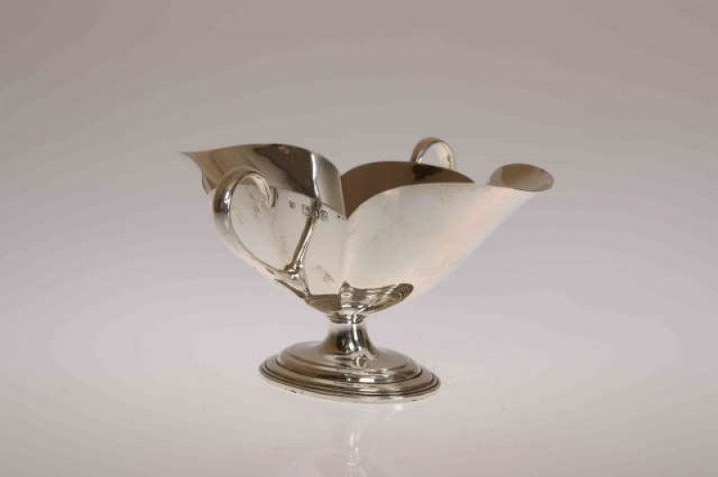 A LATE VICTORIAN SILVER DOUBLE SAUCEBOAT, Thomas Bradbury, London 1896, with twin lug handles and reeded oval foot. 4.9oz, 17cm wide