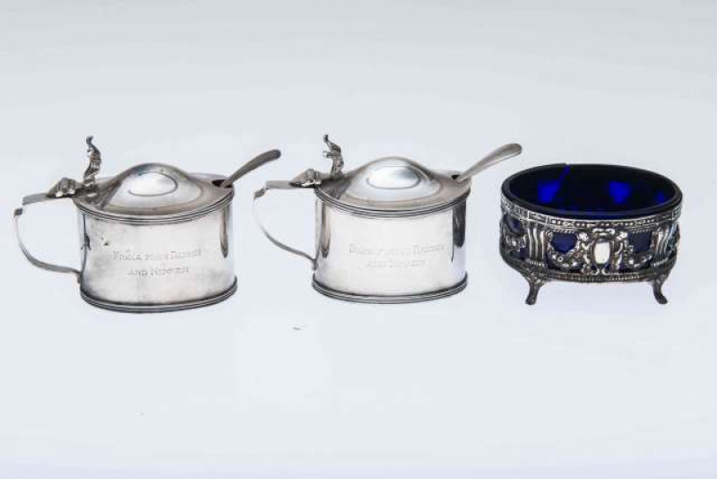 A PAIR OF EDWARDIAN SILVER OVAL MUSTARD POTS, Stokes & Ireland, Chester 1929 and 1931, with presentation engraving; together with A VICTORIAN SILVER SALT, London 1888. (3) Salt 7.5cm