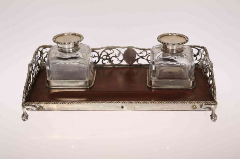 A SILVER INKSTAND, with pierced three-quarter gallery and ball and claw feet, the pair of inkwells hallmarked London 1890. 24.5cm by 13cm
