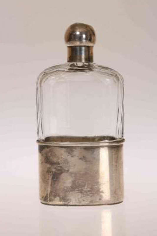 A VICTORIAN SILVER MOUNTED HIP FLASK, Frederick Purnell, London 1873, with cut-glass body and screw top. 15.5cm