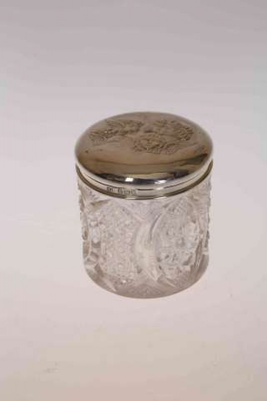 AN EDWARDIAN SILVER TOPPED JAR, H. Matthews, Birmingham 1910, the top embossed with cherubs. 6.5cm