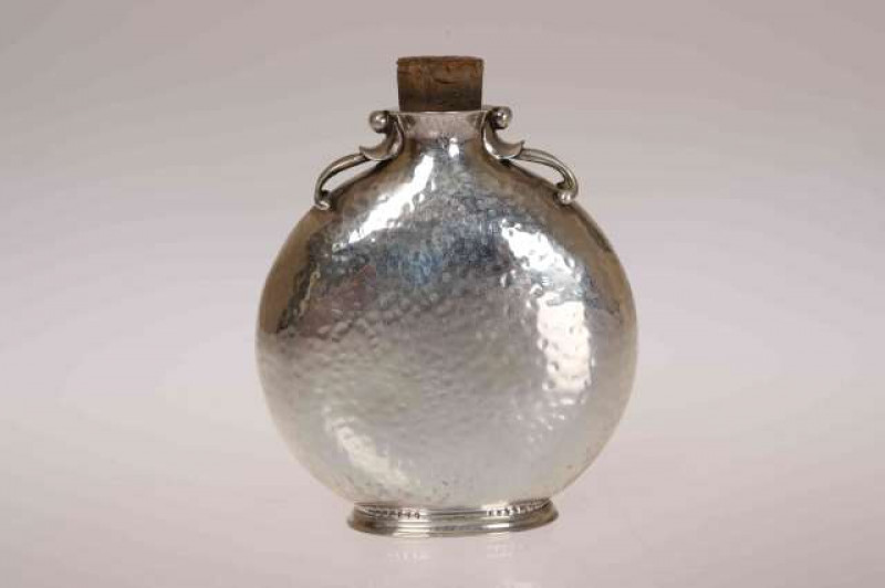 GEORG JENSEN, A STERLING SILVER SCENT FLASK, early 20th Century, moon shaped with hammered finish, no. 475, stamped marks. 8.5cm (excluding cork)