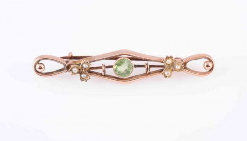 A COLLECTION OF BROOCHES, to include A PERIDOT AND SEED PEARL BROOCH, the circular cut peridot collet set within a pierced mount with three seed pearls set to each end.  A LATE VICTORIAN PERIDOT BAR BROOCH,  the circular mixed-cut peridot millegrain colle