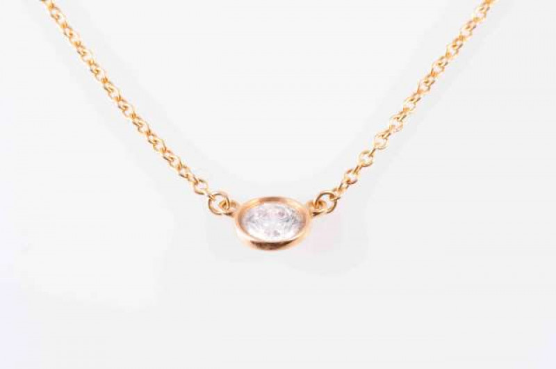 A DIAMOND PENDANT BY TIFFANY, the single brilliant cut diamond collet set to the front of a fine oval link chain with bolt ring clasp. Stamped AU 750. Marked Tiffany&Co. Total length approximately 42cm. Weight 1.9gms.