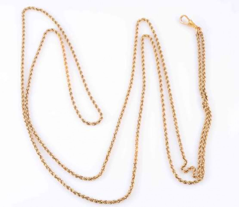 A GOLD WATCH CHAIN, CIRCA 1900, the twist design double row chain joined by an Albert clasp. Clasp stamped 15. Total length approximately 80cm. Weight 39.3gms.