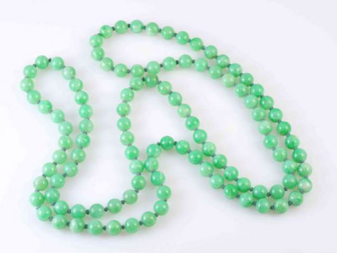 A JADEITE BEAD NECKLACE, the one hundred and eight jadeite beads stung...