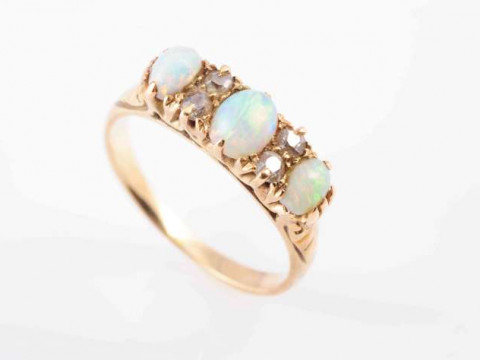 A LATE VICTORIAN OPAL AND DIAMOND RING, CIRCA 1890, set with three oval...