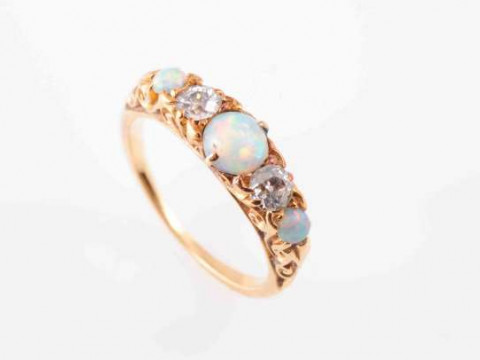 A LATE VICTORIAN OPAL AND DIAMOND RING, the three circular cabochon-cut...