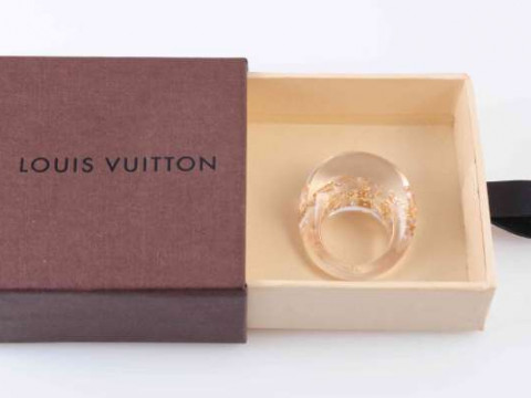 A LOUIS VUITTON LUCITE AND GOLD LEAF RING, the bombe style clear coloured...