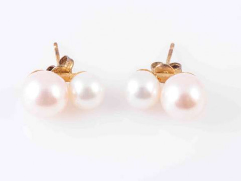 A PAIR OF DOUBLE CULTURED PEARL EAR STUDS, the two graduating cultured...
